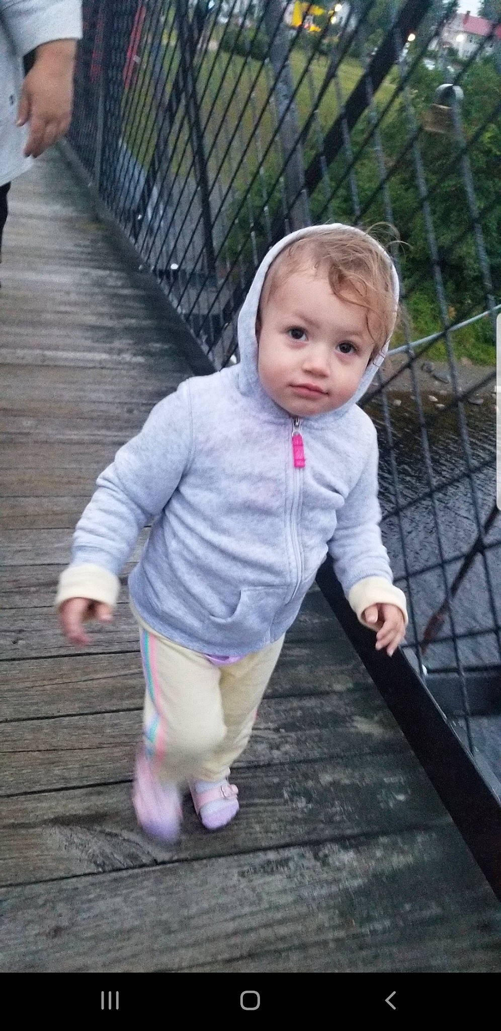 Ella Rose is registered to the contest to win money with this photo: baby, baby_toddler_clothing, cheek, child, dress, face, fence, fun, grass, happy, head, lip, nose, pattern, person, recreation, sitting, skin, sleeve, toddler