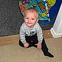 toddler, child, smiling, blue_eyes, sitting, grey_sweater, black_pants, indoor, play_mat, colorful, carpet, floor, toy, happy, cute, person, baby, young_child, casual_clothing, home