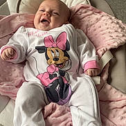 Ariella is registered to the contest to win money with this photo: baby, infant, onesie, minnie_mouse, pink_blanket, baby_seat, smiling, happy, indoors, soft_texture, footed_pajamas, child, cute, cozy, person, baby_clothing, newborn, plush_blanket, relaxed, portrait