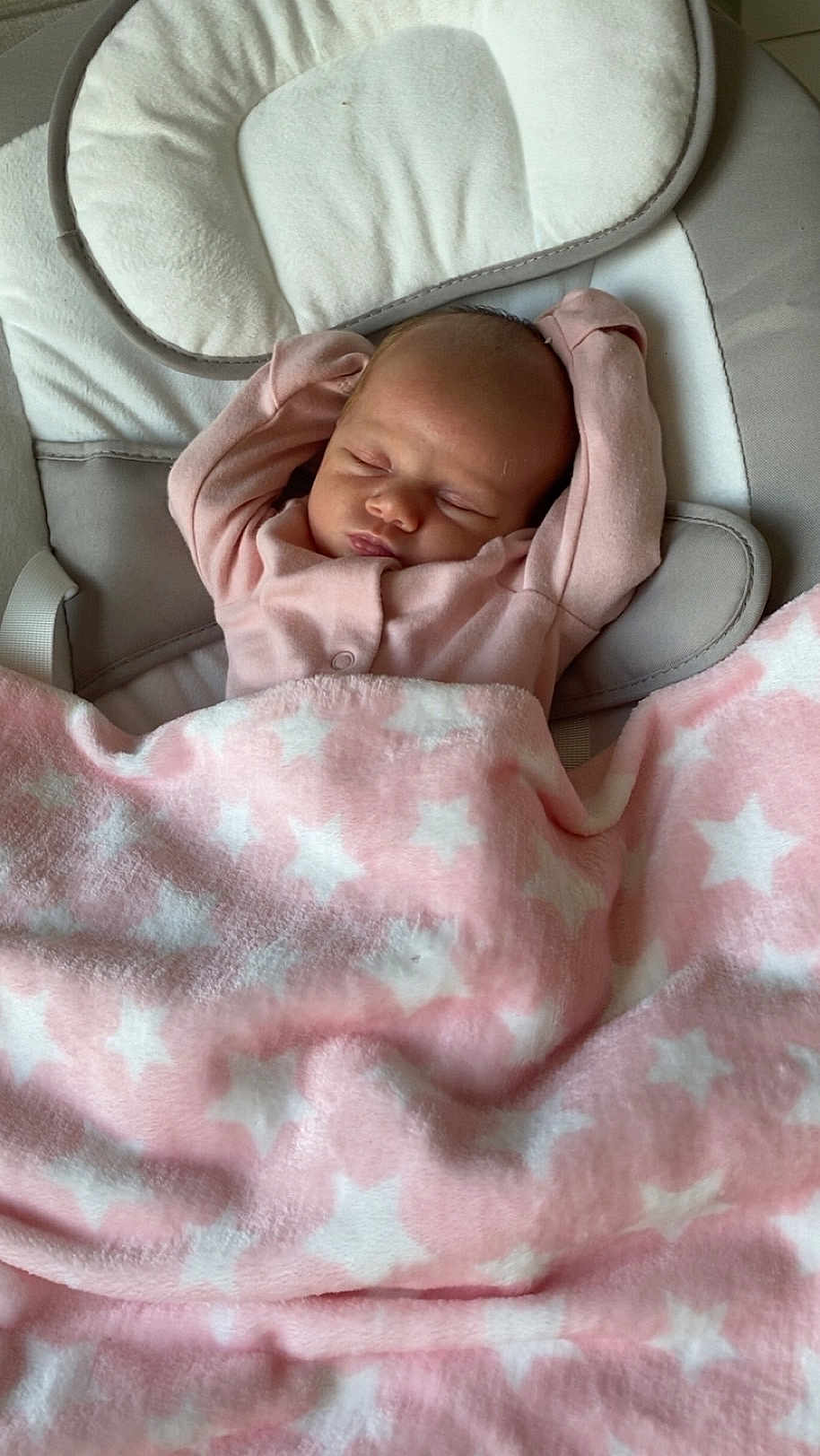 Ariella is registered to the contest to win money with this photo: baby, sleeping, blanket, pink, star_pattern, cushion, infant, cozy, soft, child, resting, indoors, cute, peaceful, wearing_clothes, head, face, small_hands, relaxing, comfort