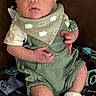 Jaxon is registered to the contest to win money with this photo: baby, infant, clothing, romper, bib, socks, blanket, face, person, newborn, cute, indoor, portrait, child, skin, hands, feet, expression, seated, comfort