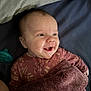 Evie joined the competition — help win amazing prizes! baby, smiling, blanket, pacifier, bed, infant, face, clothing, happy, lying_down, cute, child, person, sleepwear, portrait, toddler, soft_texture, indoors, expression, skin