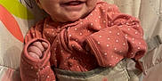 Evie is registered to the contest to win money with this photo: baby, smiling, infant, pink_clothing, polka_dot, baby_seat, colorful, animal_print, leaf_pattern, happy, cute, child, portrait, indoors, cozy, soft_fabric, playful, small_hands, relaxed, seated