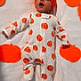 Josue Alexander is registered to the contest to win money with this photo: baby, infant, pumpkin, hat, onesie, orange, white_blanket, sleeping, cute, halloween, child, face, headwear, pattern, soft_texture, lying_down, decor, holiday, expression, indoors