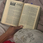 Josue Alexander joined the competition — help win amazing prizes! book, hand, pajamas, reading, bed, blanket, text, page, person, clothing, indoors, comfort, sleepwear, soft, relaxation, bedroom, story, literature, rest, cozy