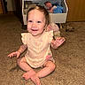 Leilani is registered to the contest to win money with this photo: baby, child, toddler, smiling, sitting, indoor, carpet, playroom, stuffed_animals, toys, bookshelf, nursery, pink_outfit, dress, barefoot, portrait, happy, waving, infant, home
