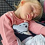 toddler, child, sleeping, car_seat, seat_belt, blanket, pink_clothing, sweatshirt, snoopy, blonde_hair, hair_clip, peaceful, indoors, portrait, young_child, resting, comfort, cute, cozy, car_interior