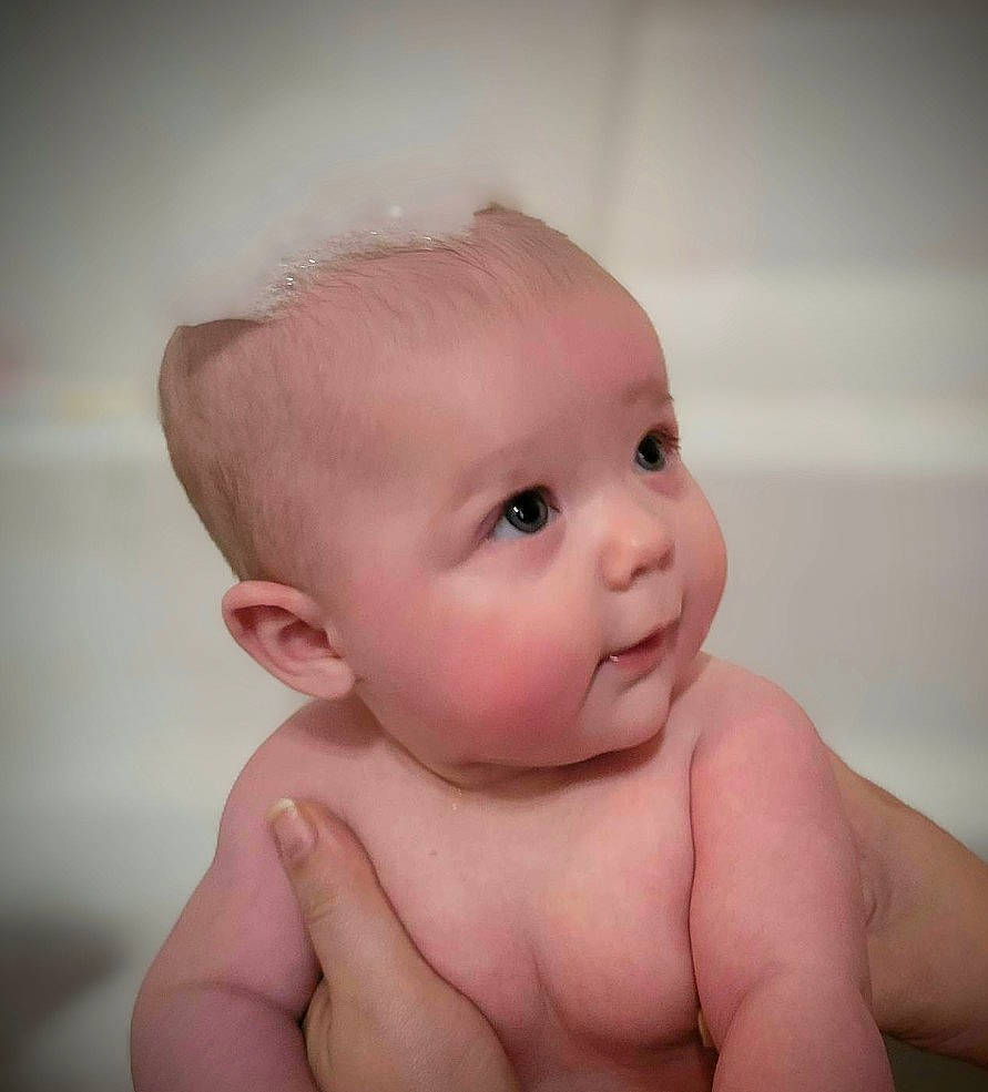 Kenzie is registered to the contest to win money with this photo: arm, baby, baby_making_funny_faces, cheek, chest, ear, eye, eyelash, finger, gesture, hand, happy, human_body, iris, lip, nose, person, skin, stomach, thumb