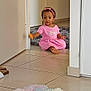 Elyssa participe au concours pour gagner de l'argent avec cette photo : toddler, child, pink_dress, headband, toy, indoor, floor, tile, rug, colorful_rug, door, home, wall, barefoot, sitting, curly_hair, person, young_child, playful, casual