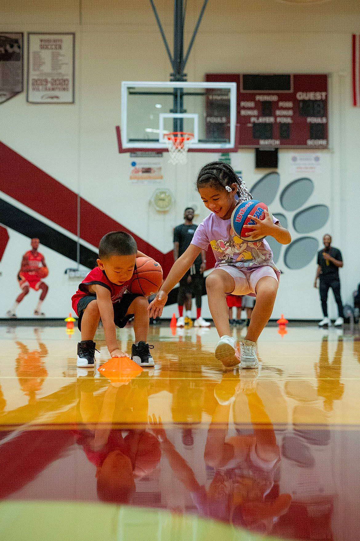 Tiana is registered to the contest to win money with this photo: art, ball, basketball_hoop, blurred, competition_event, field_house, floor, flooring, footwear, joy, leisure, person, player, recreation, shoe, shorts, sneakers, sports, sports_equipment, sportswear