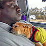 Roscoe is registered to the contest to win money with this photo: animal, calm, car_interior, close_up, daytime, dog, gray_shirt, harness, human, man, pet, resting, road, seatbelt, side_profile, sleeping_dog, transportation, trees_outside, window, yellow_shirt