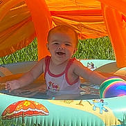 Celesté joined the competition — help win amazing prizes! baby, backyard, beach_ball, cartoon, child, grass, happy, infant, inflatable_pool, orange, outdoor, playtime, portrait, sitting, smiling, summer, sunlight, swimming_pool, tank_top, water