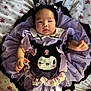 Ingsy is registered to the contest to win money with this photo: baby, child, infant, face, purple_dress, headband, cat_ears, blanket, floral_pattern, cute, smiling, lying_down, indoors, soft_toys, costume, adorable, person, young, playful, portrait