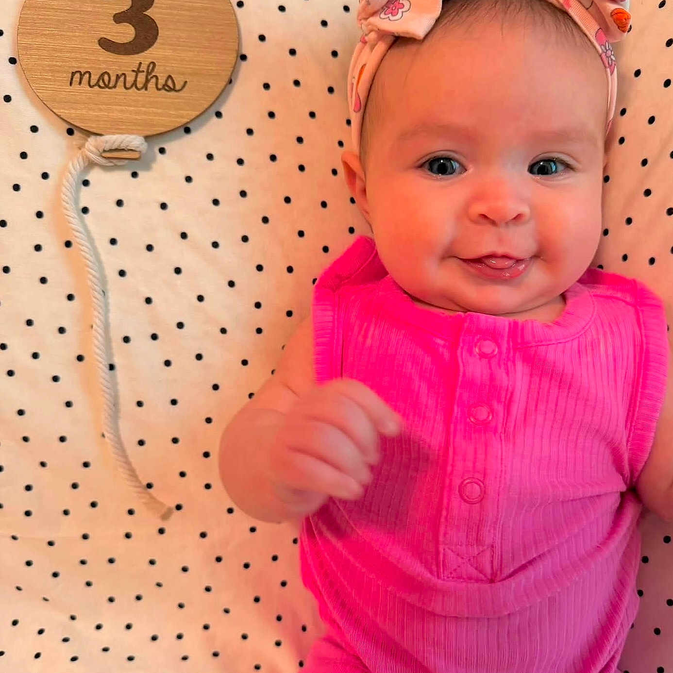 Aurora joined the competition — help win amazing prizes! baby, infant, child, smile, pink_clothing, headband, bow, polka_dot, blanket, wooden_sign, months, cute, portrait, happy, skin, face, eyes, hand, lying_down, indoors
