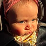 Aurora is registered to the contest to win money with this photo: baby, child, face, blue_eyes, headband, pink, floral_clothing, car_seat, sunlight, close_up, infant, cute, portrait, strapped_in, young_child, expression, skin, soft_light, indoors, seatbelt