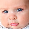 baby, close_up, face, blue_eyes, infant, skin, pink_lips, white_shirt, cute, child, portrait, young, soft_skin, expression, looking, human, newborn, adorable, innocence, head