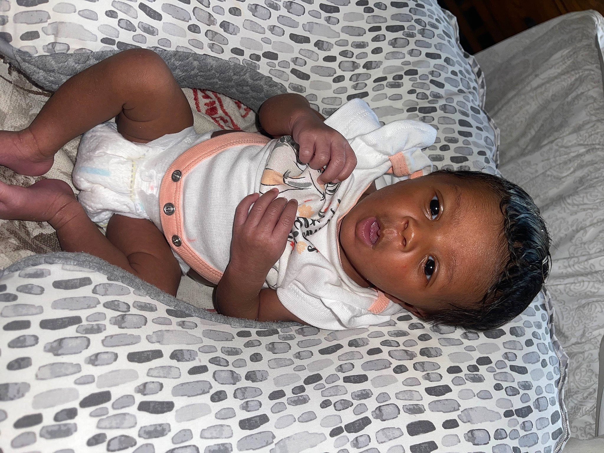 Londyn is registered to the contest to win money with this photo: abdomen, baby, baby_toddler_clothing, chest, child, comfort, flooring, foot, fun, human_body, joint, linens, mouth, pattern, person, skin, textile, thigh, toddler, trunk
