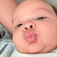 Mathias joined the competition — help win amazing prizes! baby, face, closeup, pout, tongue, chubby_cheeks, blanket, infant, cute, skin, person, expression, mouth, eyes, head, human, clothing, arm, indoor, portrait