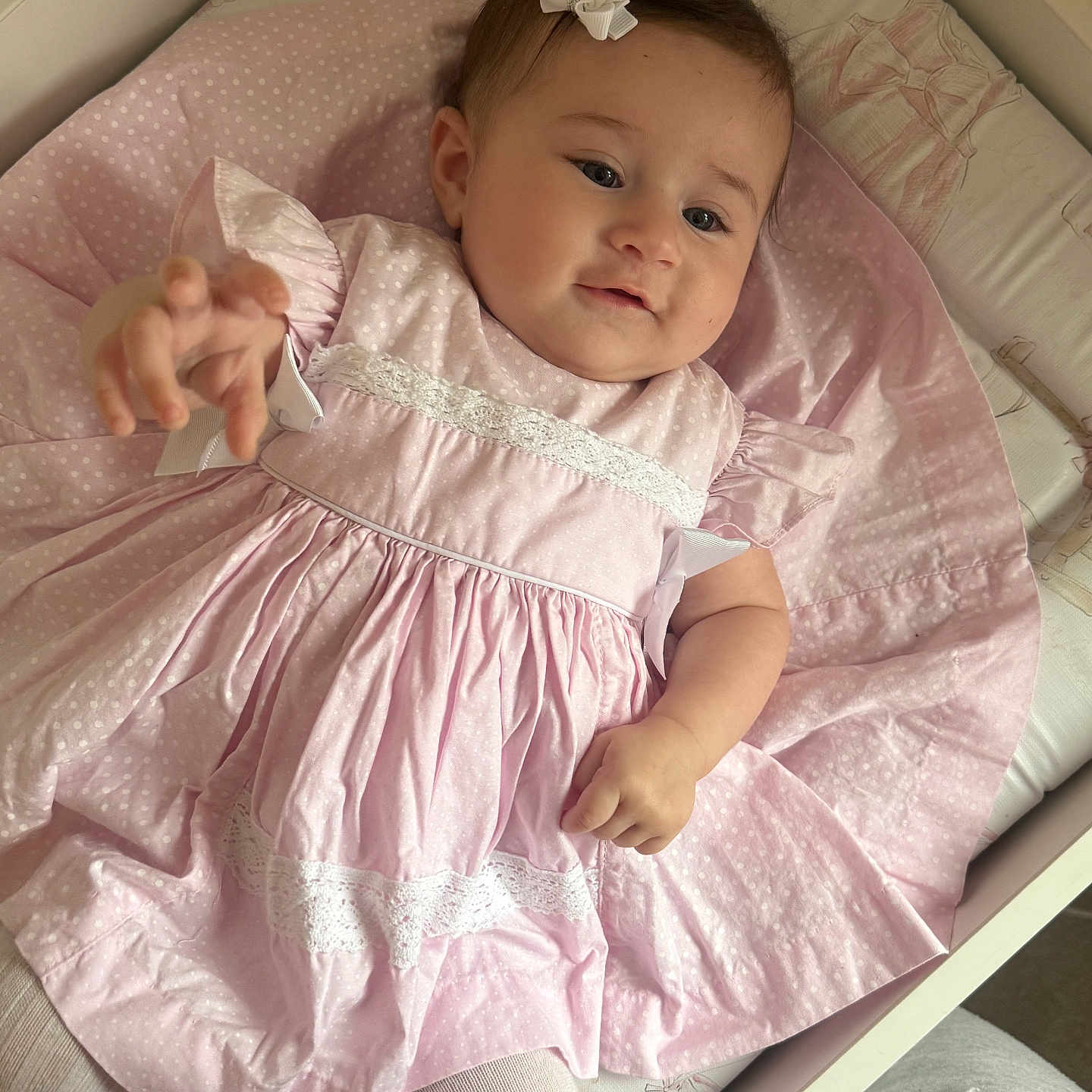 Emmelyn-Mae joined the competition — help win amazing prizes! baby, baby_clothes, bow, child, closeup, clothing, crib, cute, fabric, hand, indoors, infant, person, pink_dress, portrait, reaching, sleeping_area, soft_lighting, toddler, white_lace