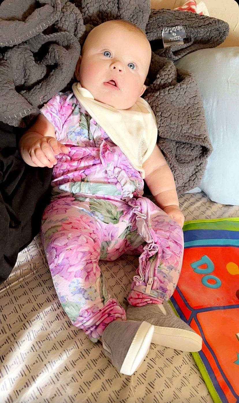 Emersyn joined the competition — help win amazing prizes! baby, baby_toddler_clothing, cheek, child, collar, comfort, eye, leg, linens, magenta, pattern, person, pink, product, sitting, skin, sleeve, sock, textile, thigh