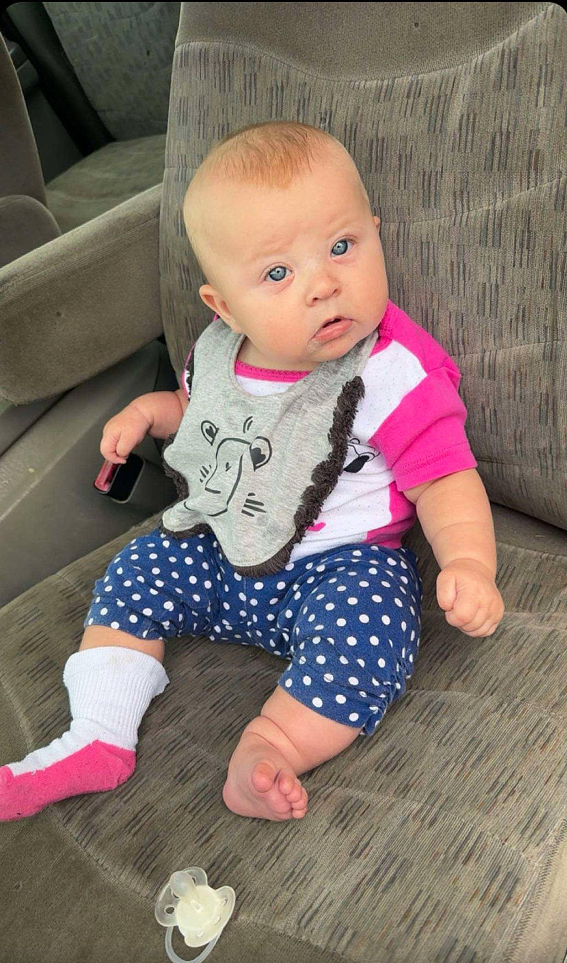 Emersyn is registered to the contest to win money with this photo: baby, baby_toddler_clothing, cheek, comfort, eye, face, finger, floor, flooring, head, human_body, joint, leg, person, pink, product, skin, sleeve, sock, surprise