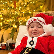 Lucca joined the competition — help win amazing prizes! baby, child, smiling, christmas, santa_claus, hat, red_clothing, holiday, festive, indoors, decorations, tree, lights, happy, portrait, cute, celebration, seasonal, warm, cozy