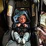 Wyatt is registered to the contest to win money with this photo: baby, car_seat, blue_clothing, hooded_outfit, infant, pouting, baby_toys, blanket, socks, indoor, cute, child, seat_belt, soft_texture, portrait, small_hands, facial_expression, cozy, newborn, baby_accessories