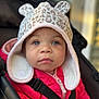 toddler, child, hat, pink_jacket, stroller, blue_eyes, face, baby, cute, winter_clothing, animal_print, portrait, outdoor, seat_belt, young_child, apparel, infant, cozy, warm, person