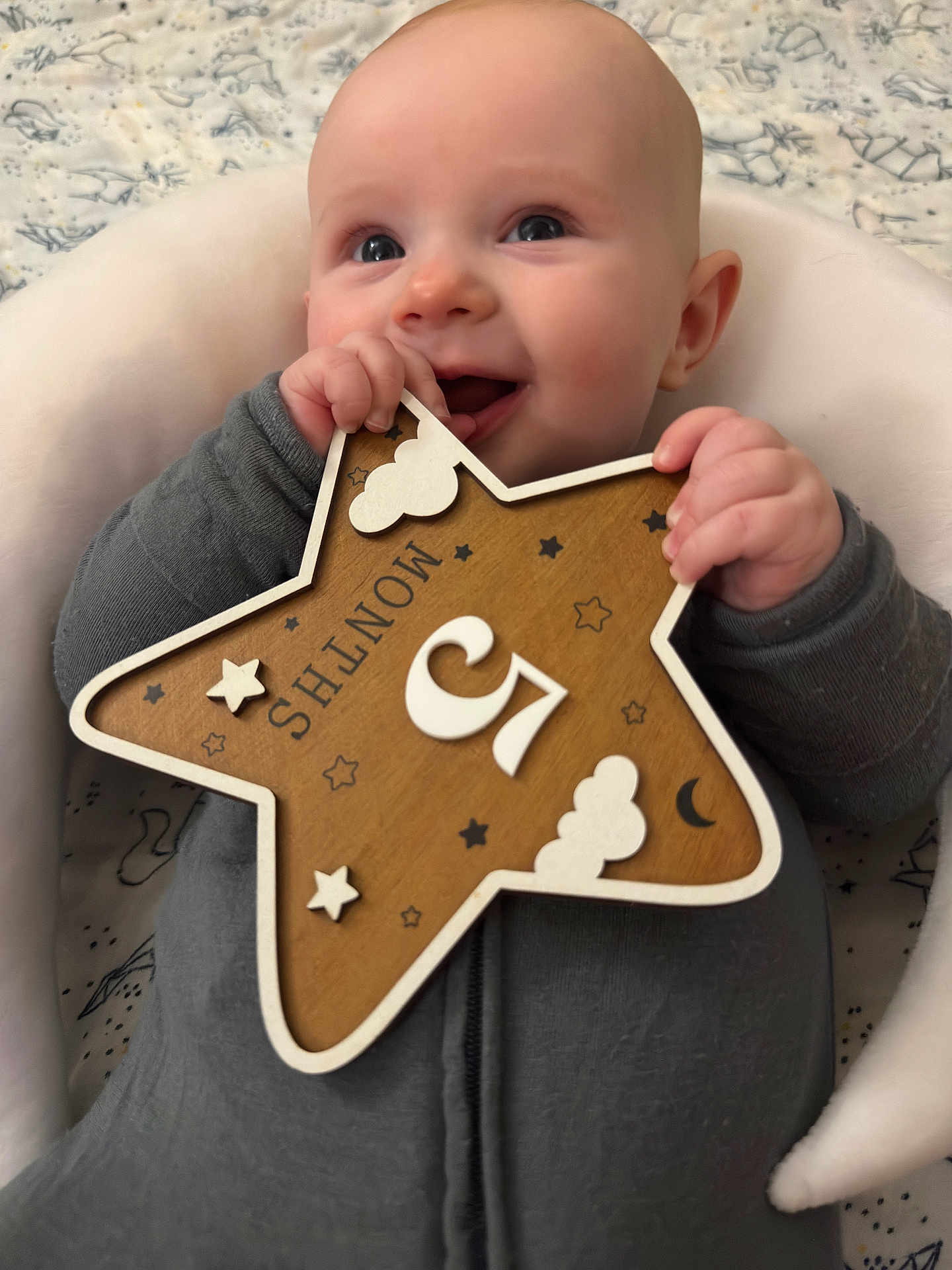 Orion joined the competition — help win amazing prizes! 5_months, baby, background, celebration, child, clothing, cushion, cute, face, hands, happy, indoor, infant, milestone, person, portrait, sitting, smiling, star, wooden_plaque