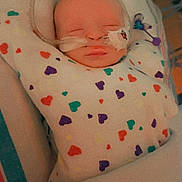 Maddox joined the competition — help win amazing prizes! baby, infant, hospital, medical_tubes, blanket, heart_pattern, sleeping, patient, child, face, bed, healthcare, newborn, swaddled, cute, resting, person, indoors, vital_signs, care