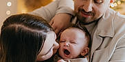 Noah participe au concours pour gagner de l'argent avec cette photo : baby, yawning, family, mother, father, love, warm_lighting, indoors, cozy, holding, portrait, happy, cute, parenthood, affection, smiling, casual_clothing, watch, hair, skin