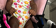Daige Dior joined the competition — help win amazing prizes! baby, child, smiling, car_seat, pink, floral_clothing, curly_hair, bows, shoes, indoor, cute, happy, infant, person, seatbelt, floor_tiles, skin, tongue, playful, closeup