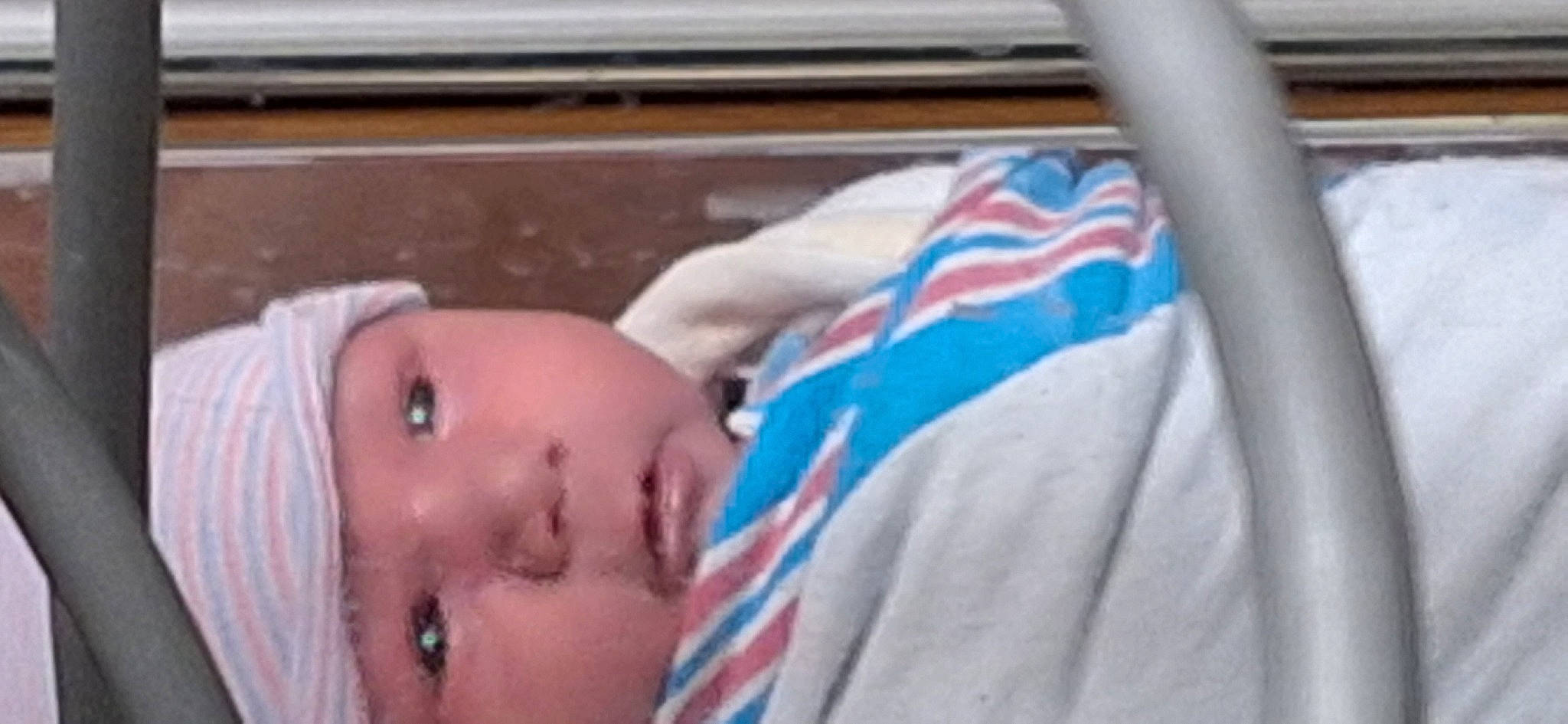 Kyle is registered to the contest to win money with this photo: baby, baby_products, baby_safety, baby_toddler_clothing, bedtime, cheek, chest, child, comfort, electric_blue, eyebrow, eyelash, headwear, infant_bed, iris, linens, nap, nose, person, room