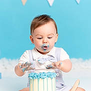 Teddy joined the competition — help win amazing prizes! baby, child, cake, blue_frosting, face_paint, hands, birthday, celebration, sitting, white_shirt, bow_tie, suspenders, background, letter_e, messy, food, cute, portrait, indoors, fun