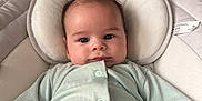 Albie is registered to the contest to win money with this photo: baby, infant, onesie, mocha, face, cushion, baby_chair, plush_toy, lion_toy, stairs, indoor, child, soft_lighting, nursery, cozy, person, cute, portrait, clothing, home