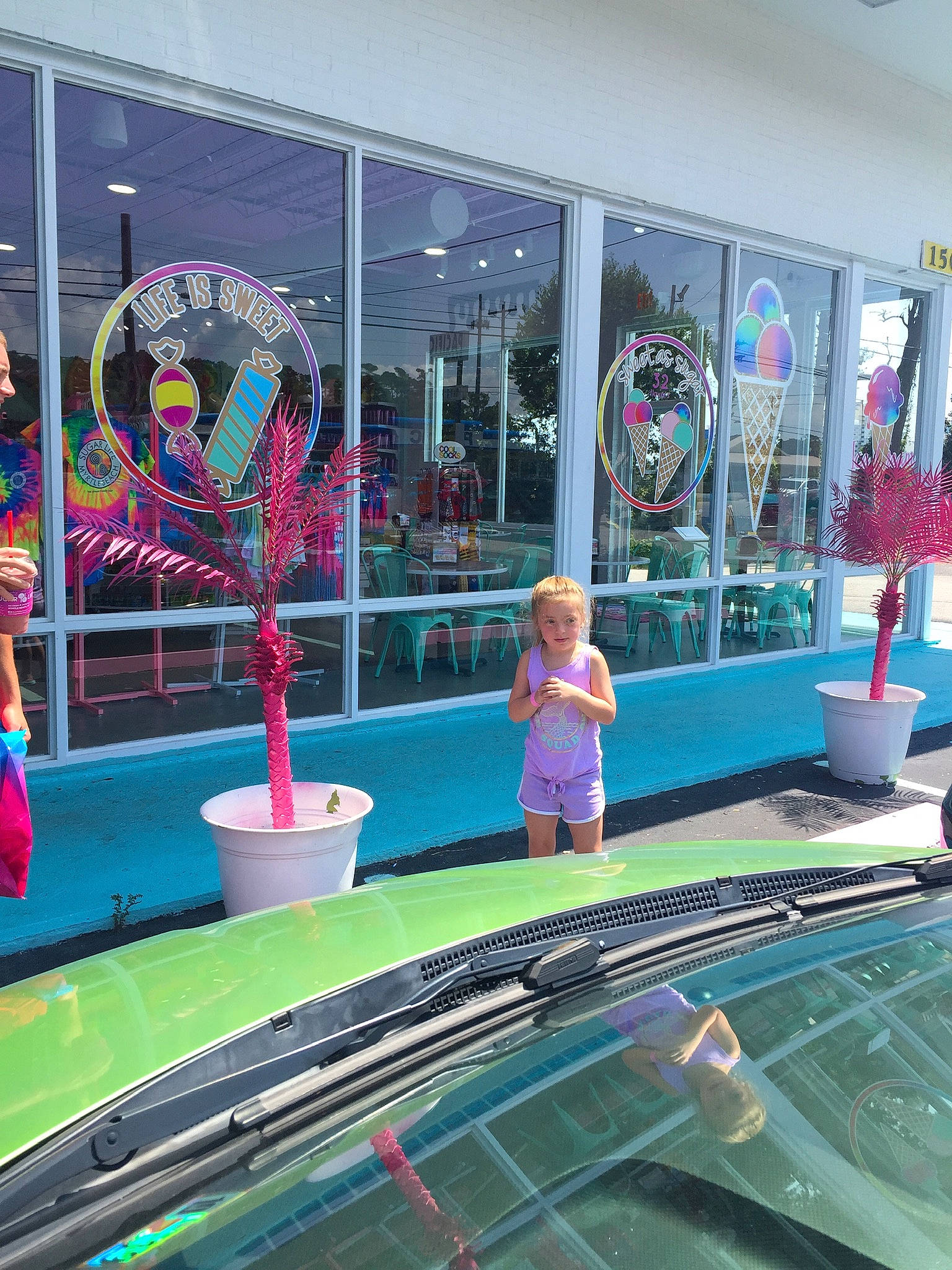 June is registered to the contest to win money with this photo: architecture, building, fun, glass, leisure, leisure_centre, person, pink, recreation, reflection, water_feature, world