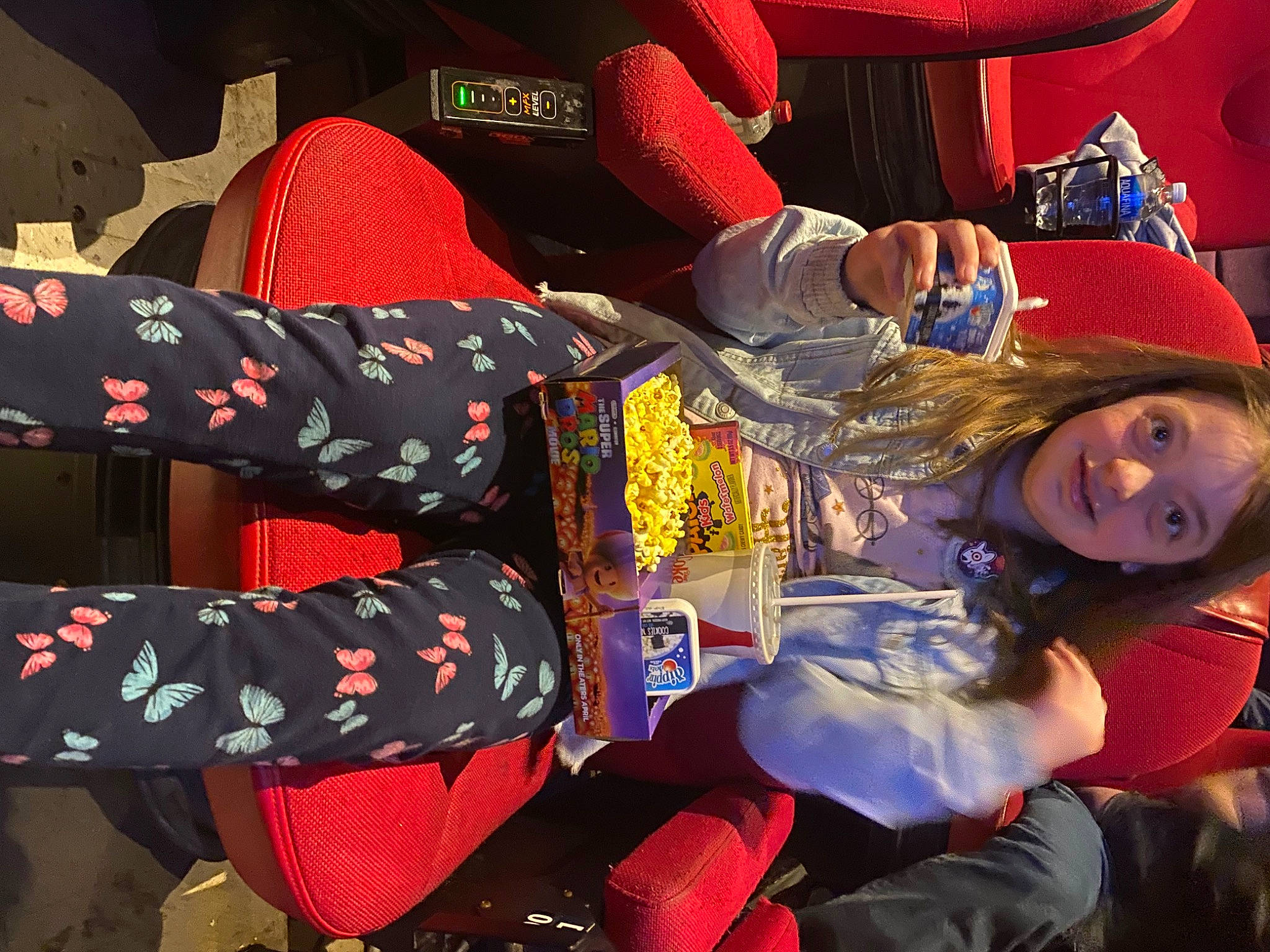 June joined the competition — help win amazing prizes! carmine, child, costume, event, fictional_character, fun, happy, hat, human_leg, pattern, person, red, sitting, smile, thigh, tree