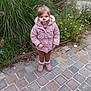 child, face_paint, pink_coat, boots, outdoor, grass, flowers, cobblestone, path, autumn, nature, person, cute, winter_clothing, young, playful, holiday, scenery, portrait, casual