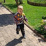 Raphaël a rejoint le concours — aidez-le/la à gagner de superbes lots ! child, toddler, walking, outdoor, sunny, shadow, pavement, grass, flowers, cartoon_clothing, sneakers, nature, pathway, greenery, casual_wear, daylight, young_child, playful, portrait, park