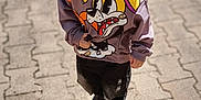 Raphaël participe au concours pour gagner de l'argent avec cette photo : child, boy, hoodie, cartoon, outdoor, pavement, shadow, casual_clothing, sneakers, daylight, portrait, curious, standing, young, cute, expression, street, sunlight, fashion, casual