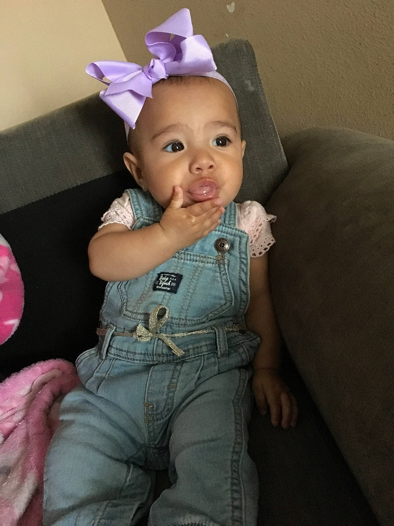 Brier is registered to the contest to win money with this photo: baby, child, ear, fun, happy, hat, head, headgear, organ, person, pink, sitting, skin, smile, toddler