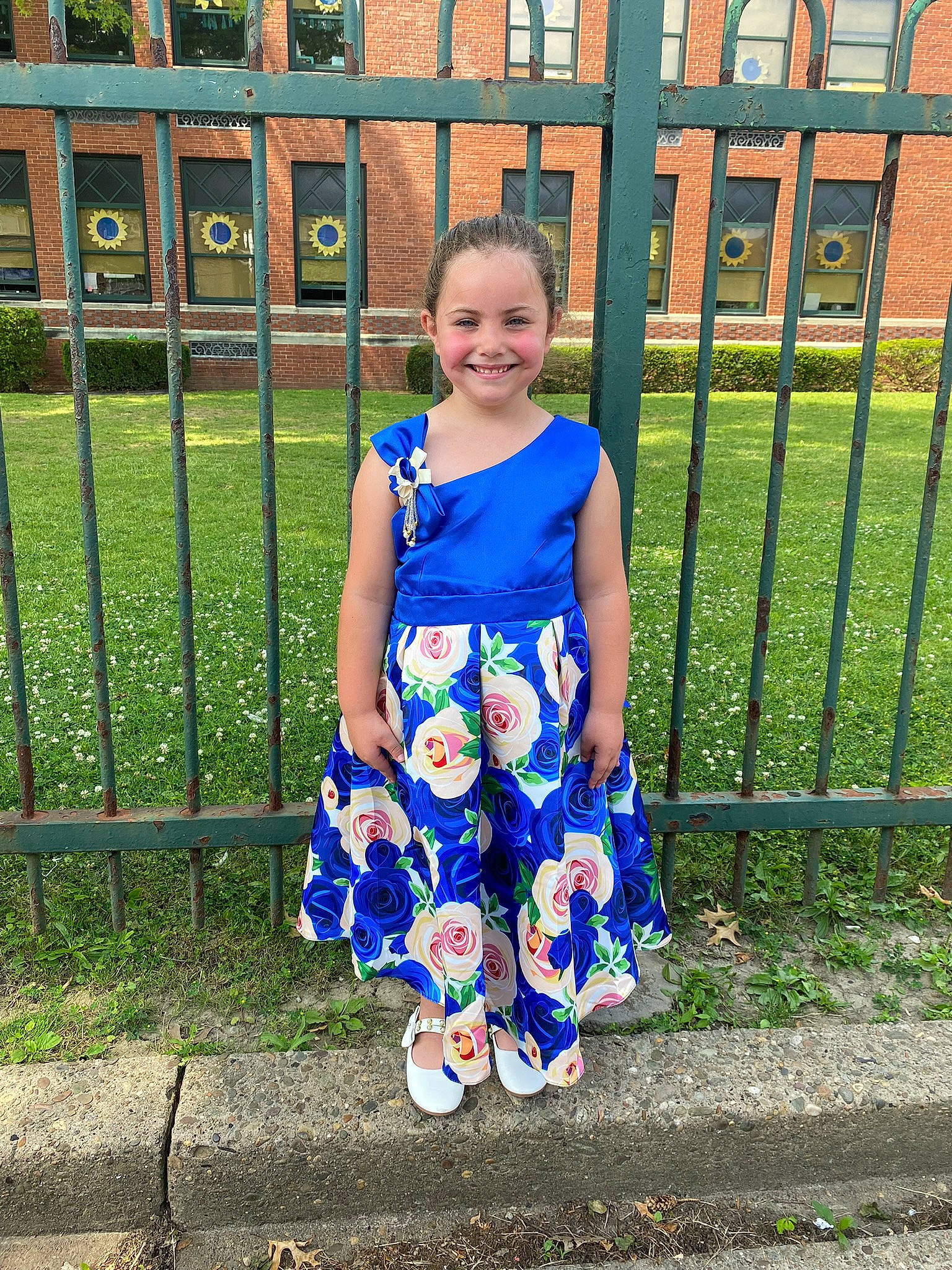 Rayna is registered to the contest to win money with this photo: baby_toddler_clothing, day_dress, dress, electric_blue, fence, fun, grass, happy, joy, leg, leisure, pattern, people_in_nature, person, sleeve, smile, spring, standing, street_fashion, summer