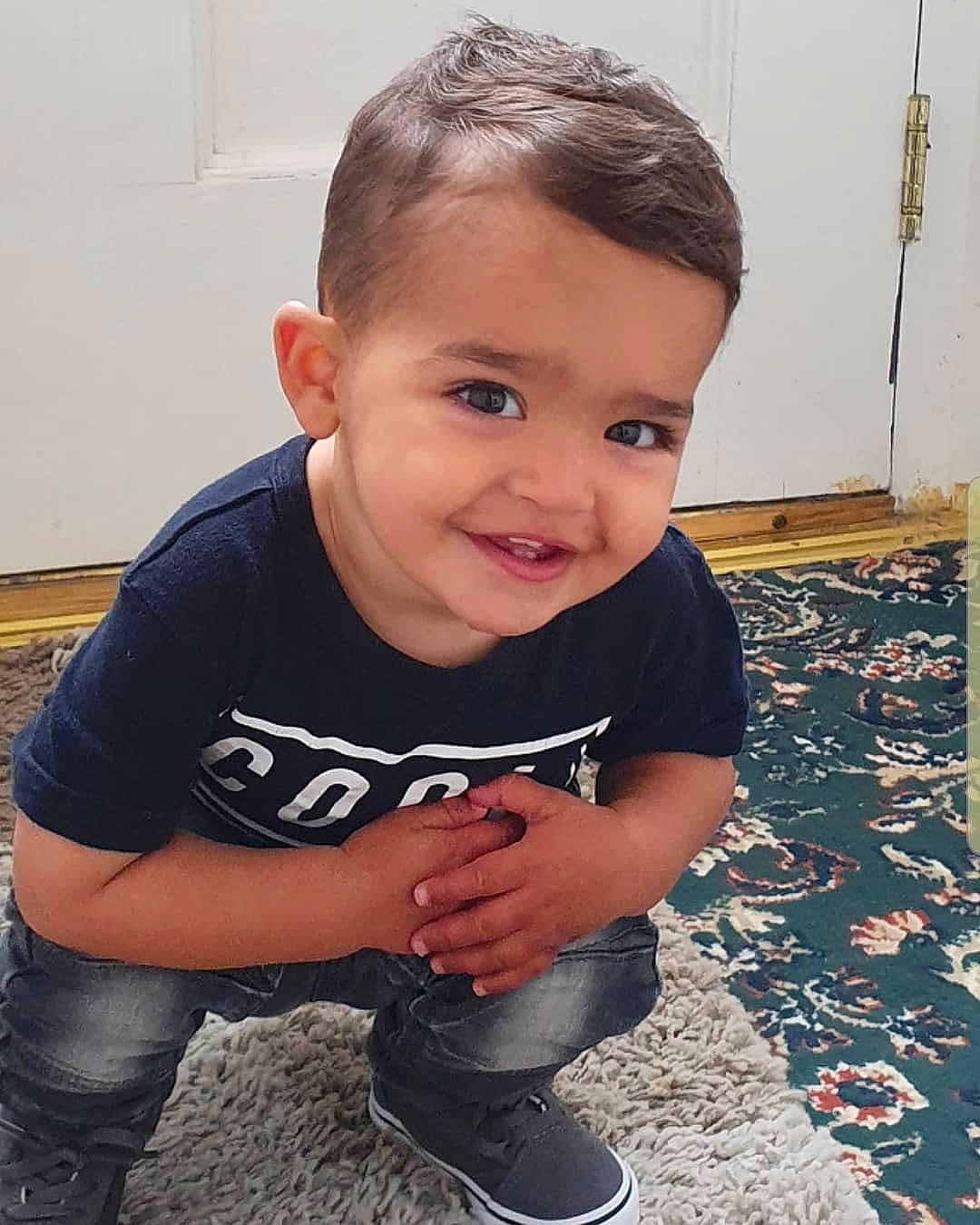 Zayden is registered to the contest to win money with this photo: arm, cheek, child, joy, leg, person, sitting, smile, t_shirt, toddler