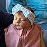 Ava is registered to the contest to win money with this photo: baby, newborn, sleeping, headband, white_bow, pink_outfit, child, infant, portrait, closeup, soft_lighting, indoor, blanket, peaceful, cute, baby_clothing, adorable, person, resting, young_child