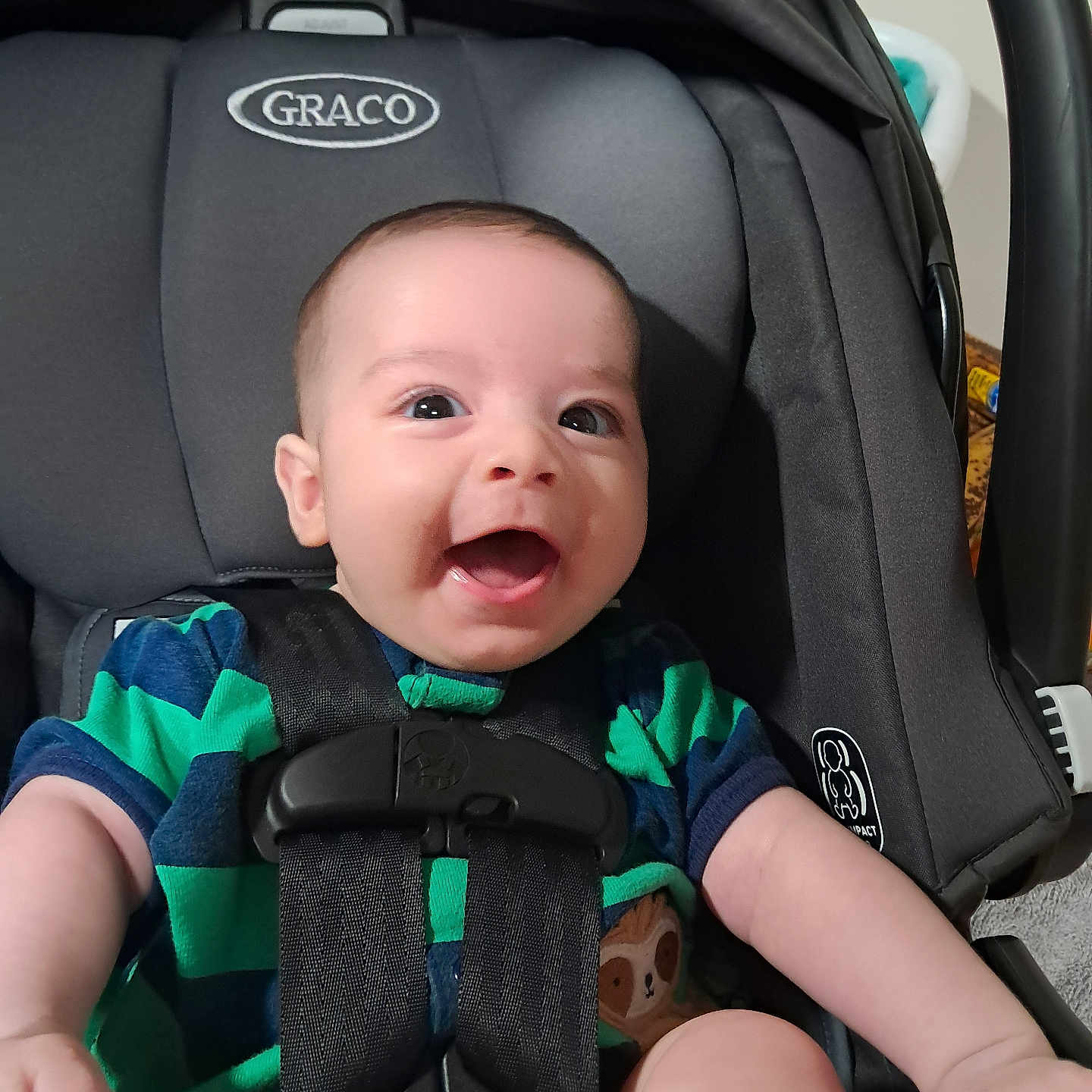 Kyren joined the competition — help win amazing prizes! baby, car_seat, graco, child, smiling, happy, infant, seat_belt, clothing, striped_shirt, indoor, person, cute, young_child, sitting, head, face, arm, closeup, photography