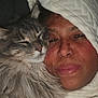 Riffann is registered to the contest to win money with this photo: cat, person, blanket, hood, cozy, fur, close_up, snuggle, pet, indoor, whiskers, portrait, sleepy, face, cuddle, bedding, soft_texture, companion, domestic_cat, night