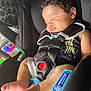 baby, bodypart, car, car_interior, carseat, clothing, cushion, face, finger, glove, hand, head, homedecor, newborn, person, photography, portrait, sleeping, transportation, vehicle