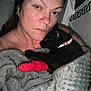 Gizmo And Nala is registered to the contest to win money with this photo: person, cat, black_cat, blanket, bed, collar, paw, cast, tattoo, jewelry, earring, necklace, closeup, indoor, sleeping, resting, cuddle, comfort, skin, expression