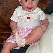 Sarahlouisejasmine is registered to the contest to win money with this photo: baby, blanket, child, couch, cozy, cute, face, foot, hand, happy, indoor, infant, pillow, pink, shirt, shorts, sitting, smiling, sock, white
