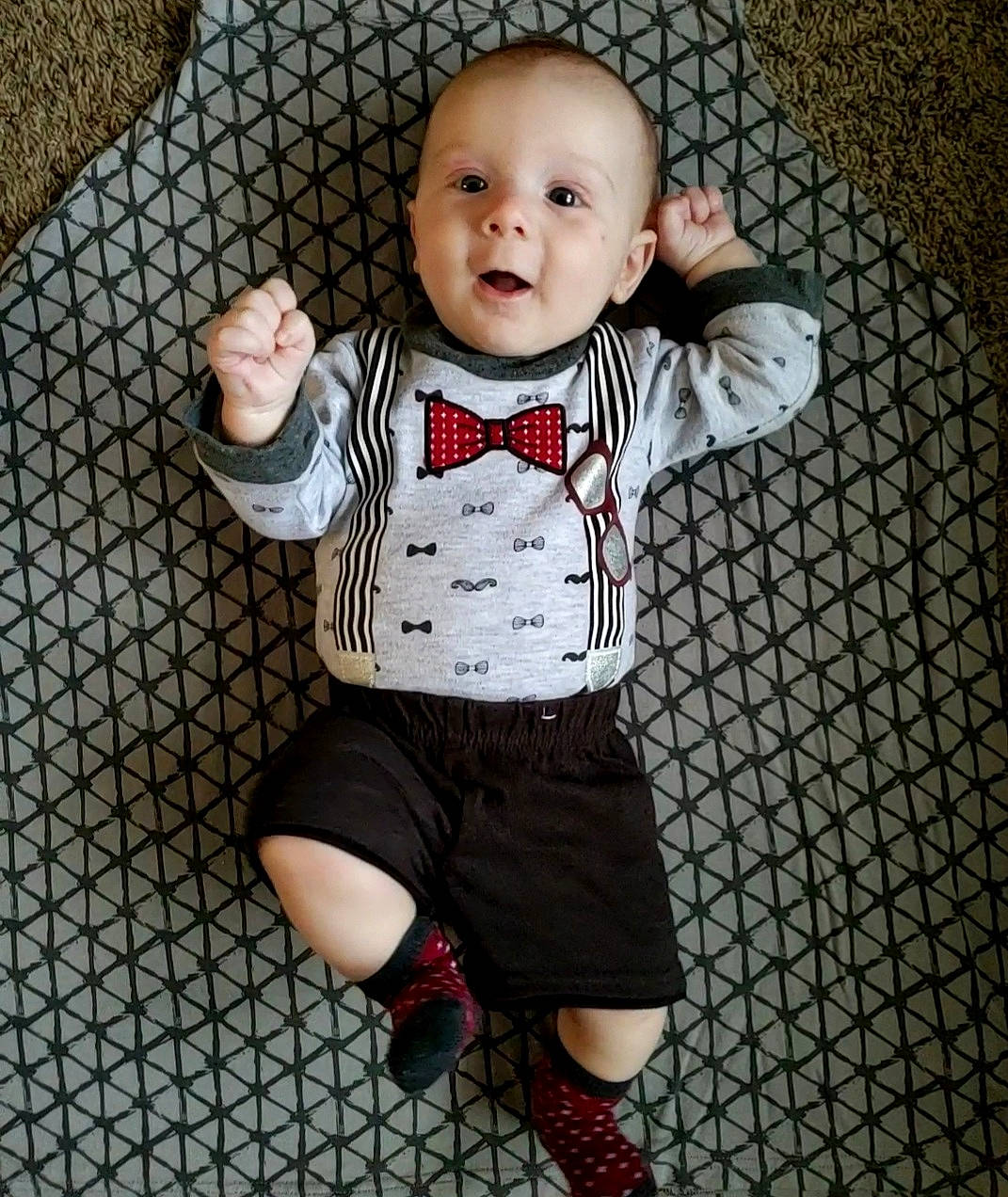 Oliver is registered to the contest to win money with this photo: baby, baby_toddler_clothing, child, collar, cool, flooring, formal_wear, happy, leg, pattern, person, sitting, sleeve, smile, standing, t_shirt, thigh, tie, toddler, toy